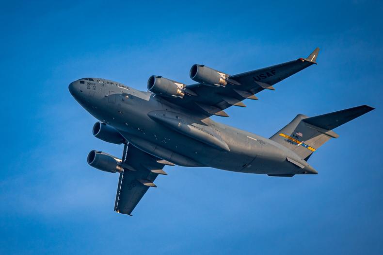 USAF cargo aircraft in flight, representing contested logistics and the importance of logistics simulation software and modeling for mission readiness